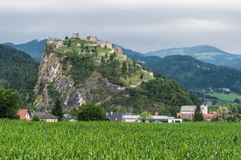 Der felsige Griffner Schlossberg mit der Burgruine auf dem Gipfel, davor der Ort Griffen
