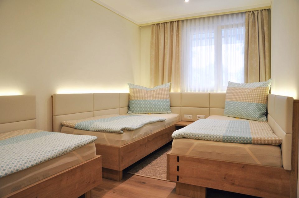 Dreibettzimmer mit drei Einzelbetten über Eck